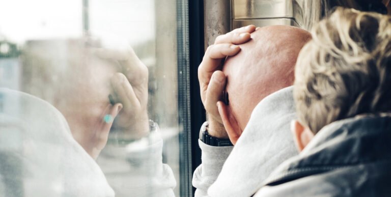 Man in a bus experiencing headache
