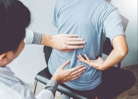 Therapist helping a man with his sciatica.