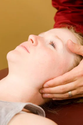 A girl experiencing and treating heavy head.