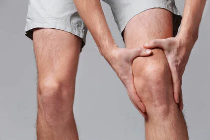 Man experiencing and managing knee pain