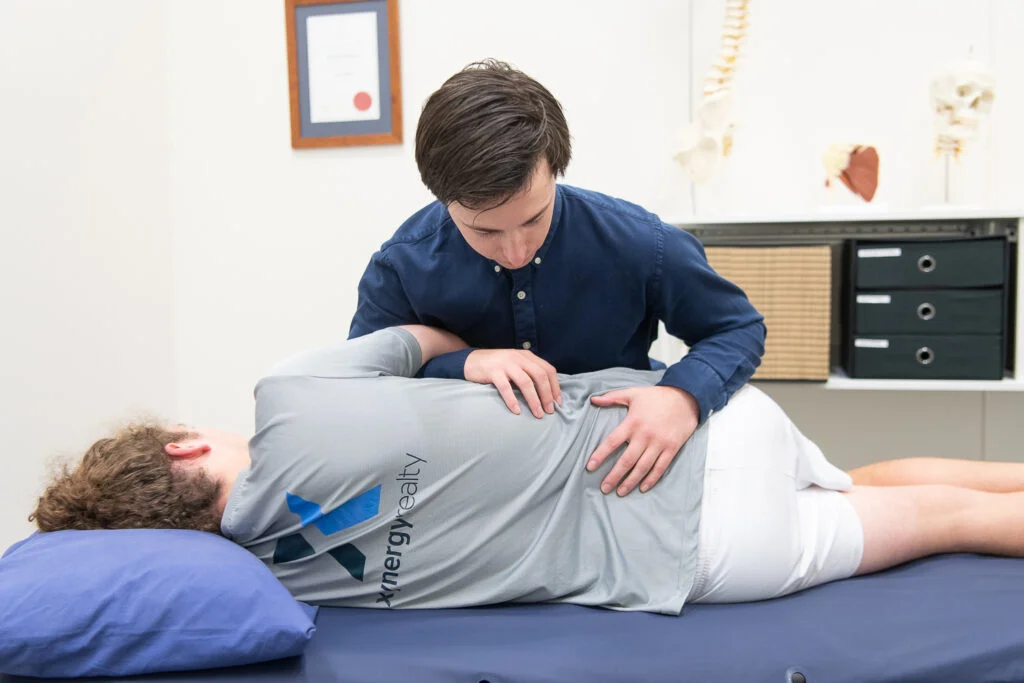 Osteo working on low back pain physio