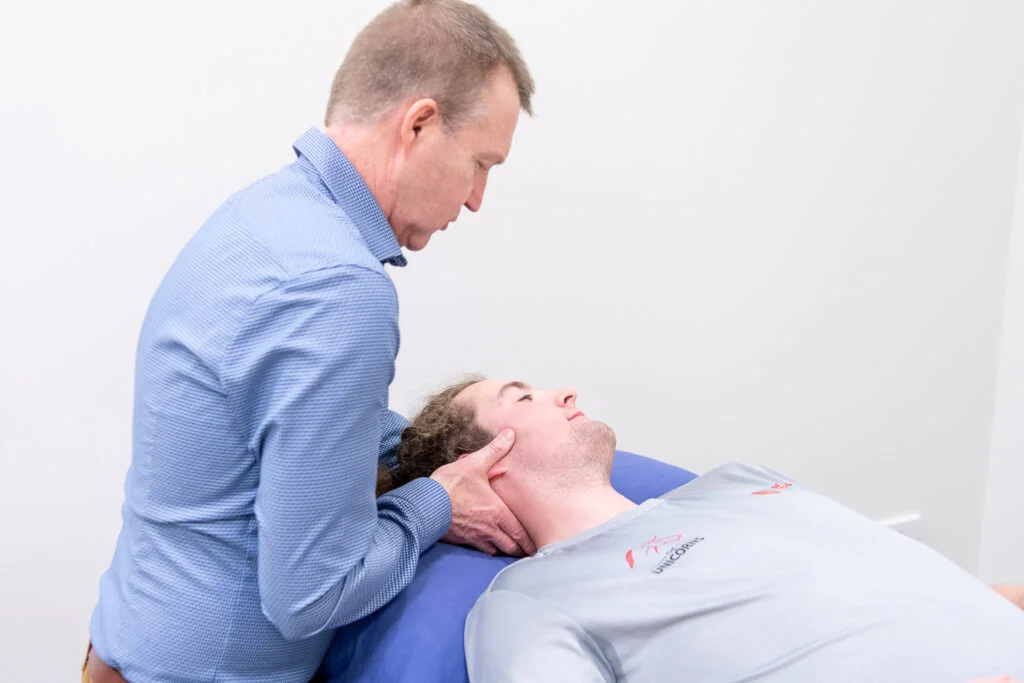 Physio performing manual therapy physio on patient