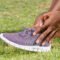 Person holding onto ankle due to recent injury