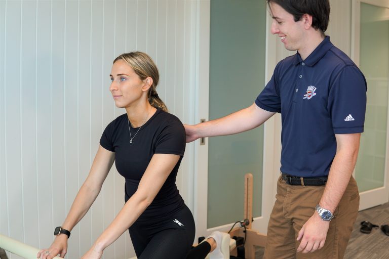 A therapist performing Clinical Pilates